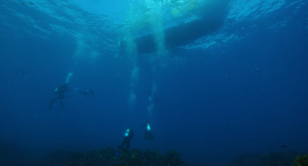 divers and a diving boat